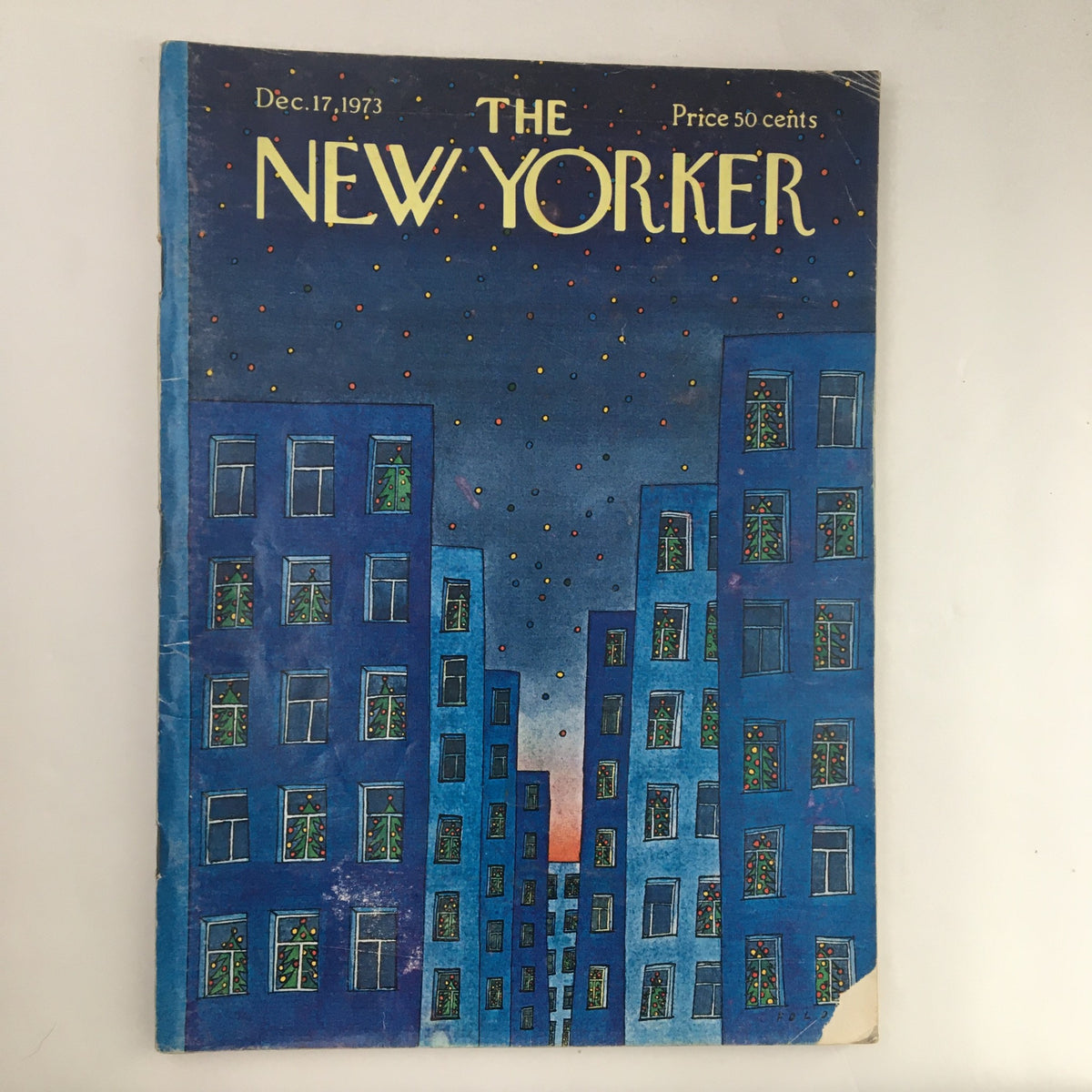 Cover of The New Yorker Magazine December 17, 1973 featuring a Christmas-themed illustration by Jean-Michel Folon, showcasing blue buildings adorned with holiday decorations.