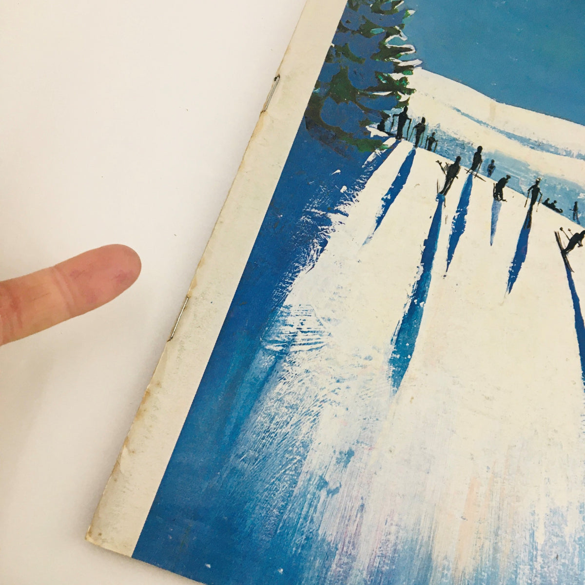 Close-up view of the edge of The New Yorker Magazine from January 20, 1973, showcasing the 'Mountain Skiing' cover art by Arthur Getz, highlighting wear and authenticity.