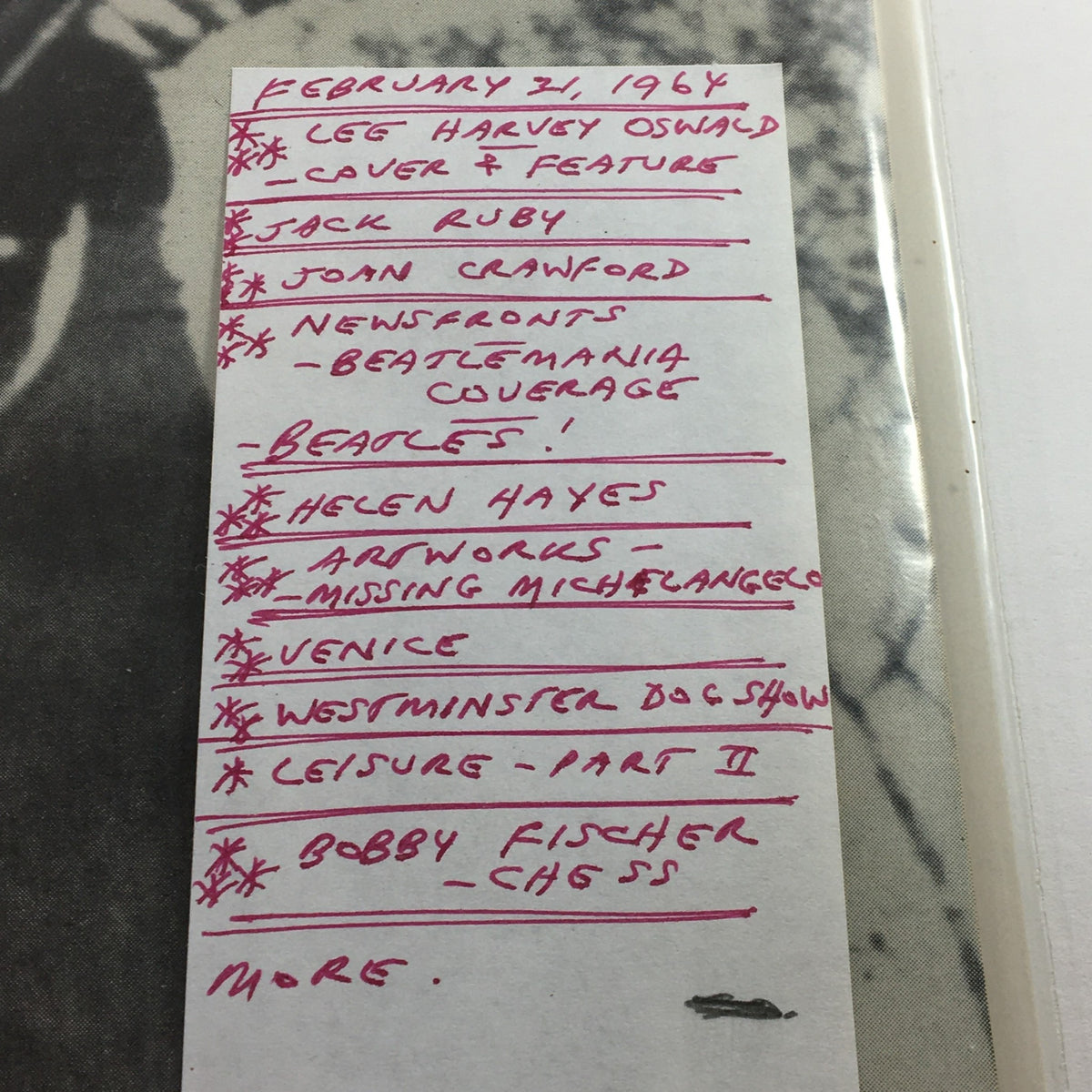 Close-up snapshot of a handwritten note on the cover of the VTG Life Magazine from February 21, 1964, listing featured articles and topics including Lee Harvey Oswald and Jack Ruby.