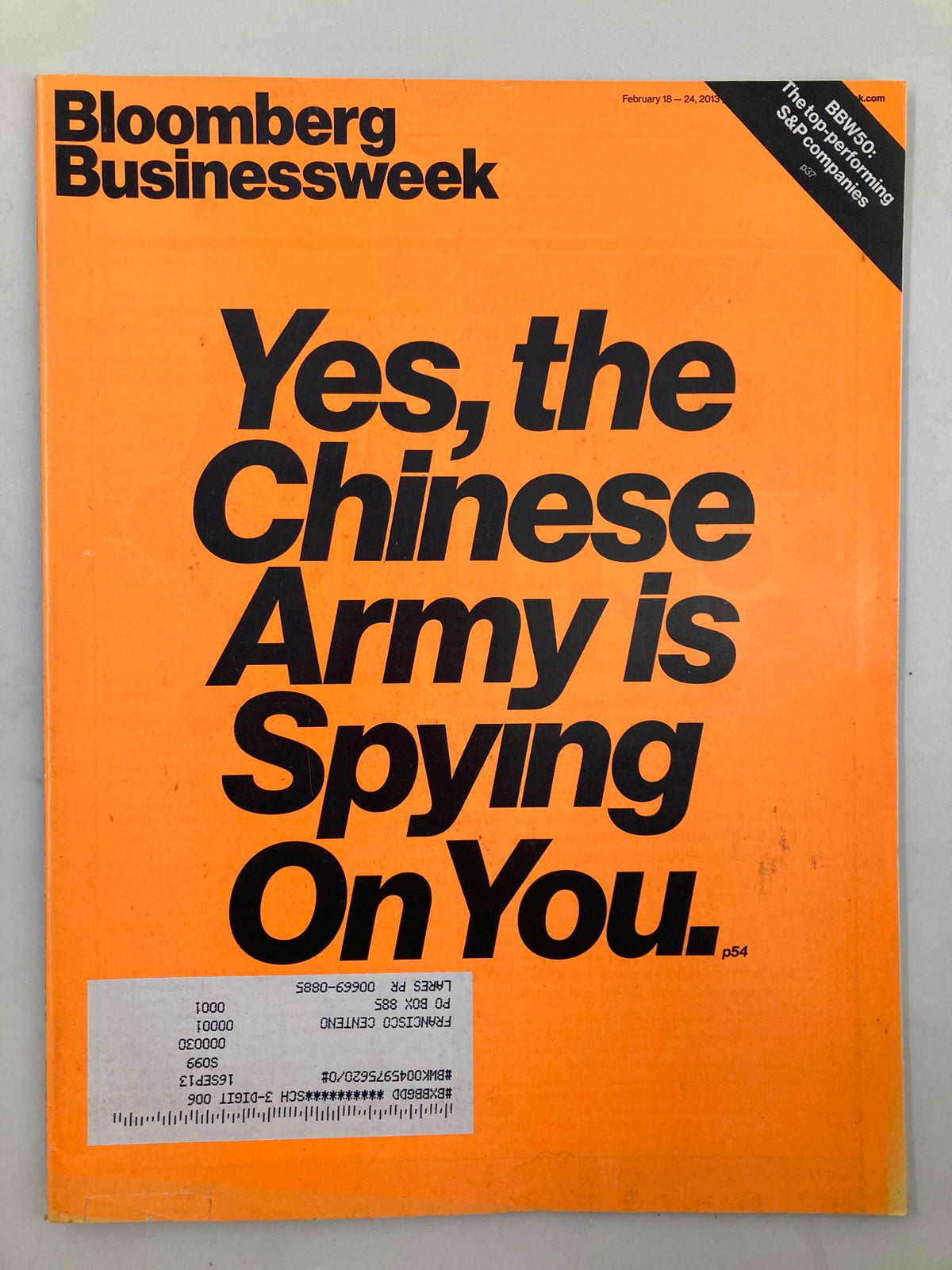 Bloomberg Businessweek Magazine cover from February 18, 2013, featuring the headline 'Yes, the Chinese Army is Spying On You'. The magazine has an orange background and includes a visible address label.