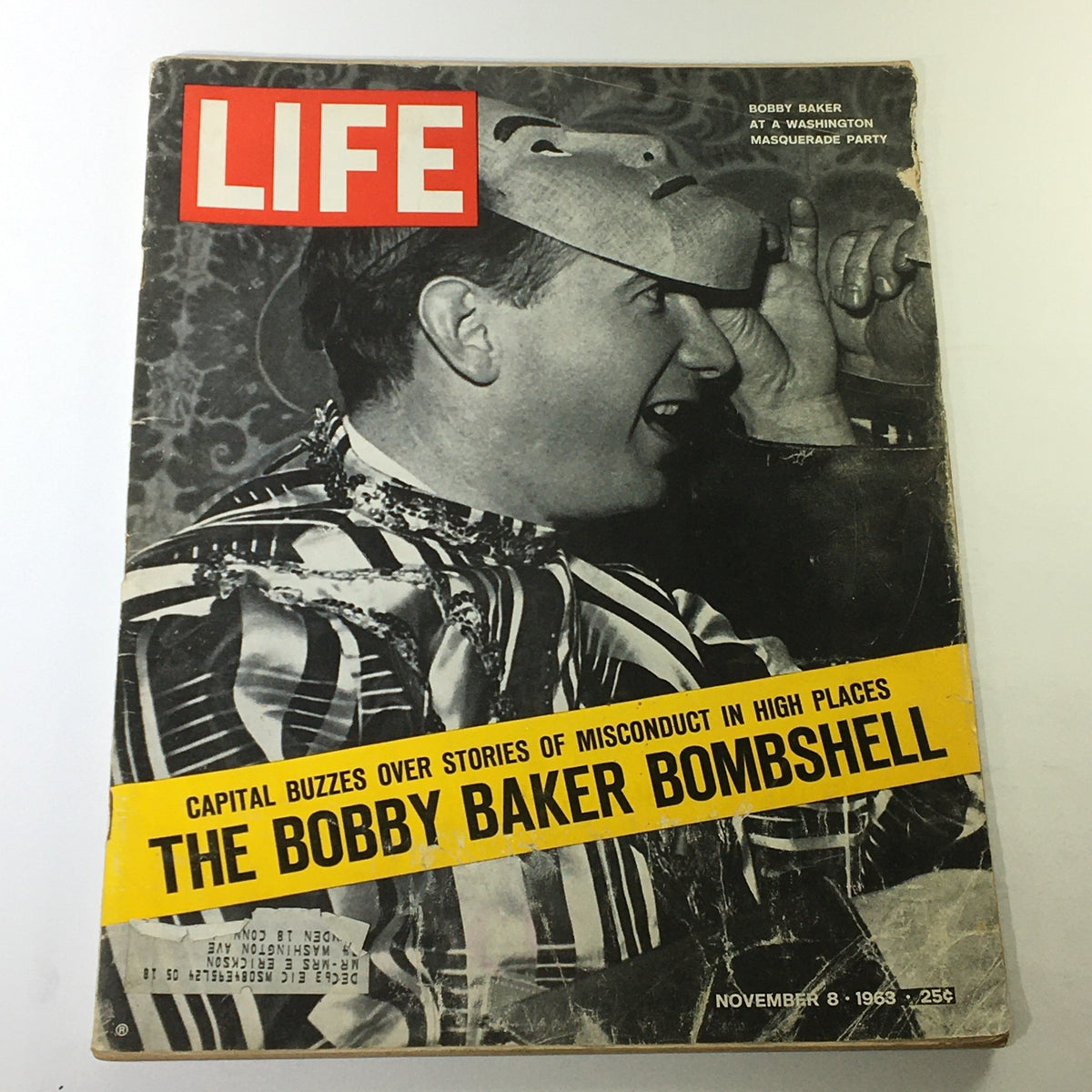Cover of Life Magazine dated November 8, 1963 featuring the Bobby Baker Bombshell. The image shows a man wearing a masquerade mask and striped attire, highlighting the bold yellow headline about political misconduct.