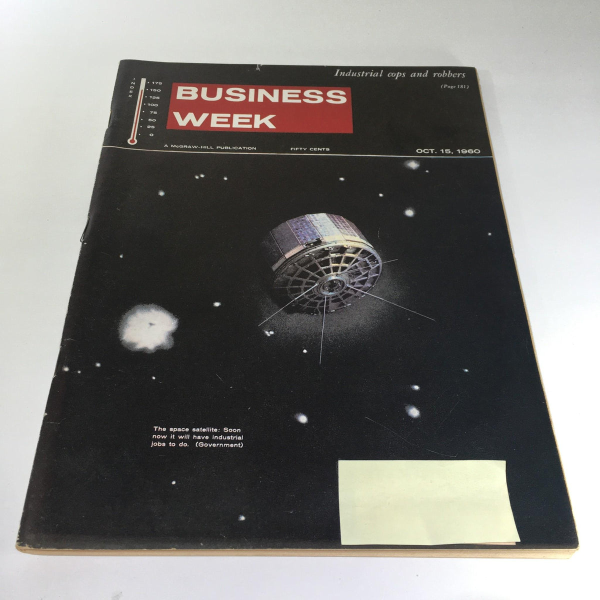 Cover of Business Week Magazine, October 15, 1960, featuring a space satellite and discussing industrial jobs. The magazine highlights the era's technological advancements, with a striking illustration of a satellite in space.