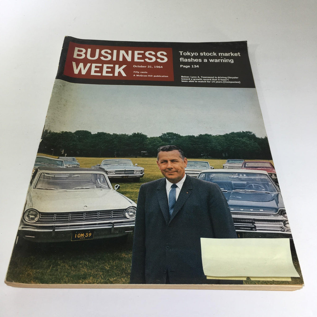 Business Week Magazine cover from October 31, 1964, featuring Lynn A. Townsend driving Chrysler with vintage cars in the background, illustrating the automotive industry of the 1960s.