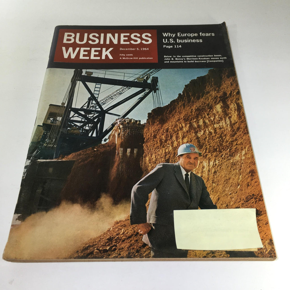 Cover of Business Week Magazine dated December 5, 1964 featuring an article titled 'Why Europe fears U.S. business' with a prominent image of a construction site and a man in a suit wearing a hard hat, symbolizing the construction industry's growth during that era.