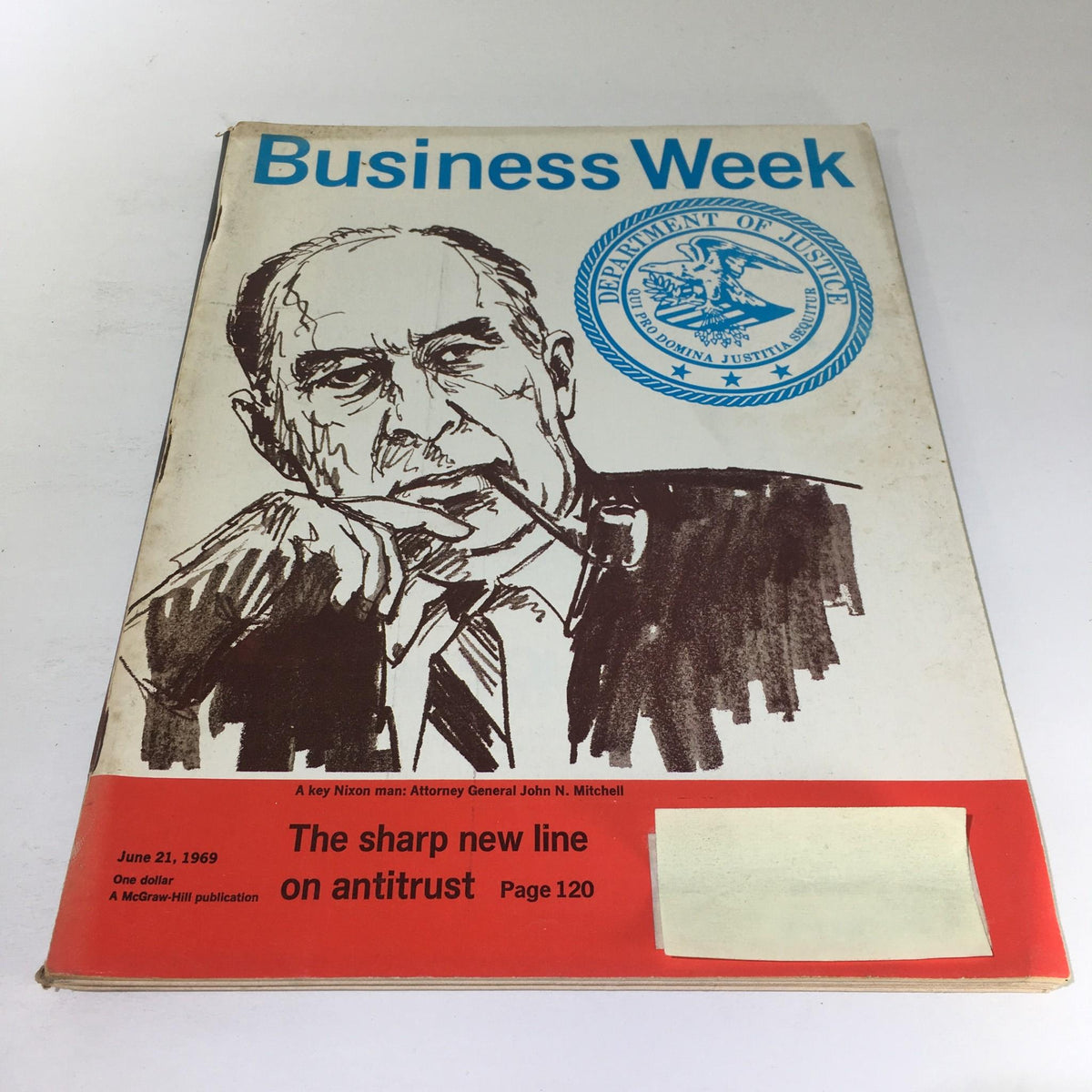 Cover of Business Week Magazine, June 21, 1969, featuring the title 'The Sharp New Line On Antitrust.' The illustration showcases a man with a pipe, labeled as Attorney General John N. Mitchell, along with the Department of Justice seal, highlighting key themes of antitrust regulations.