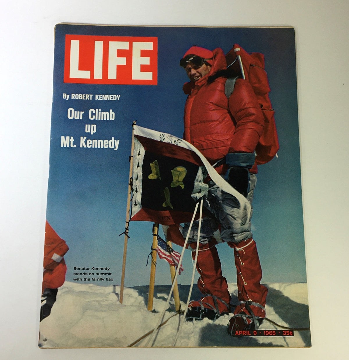 VTG Life Magazine cover from April 9, 1965 featuring Robert Kennedy's Climb up Mt. Kennedy, showcasing Senator Kennedy in red winter gear on a snowy summit with flags.