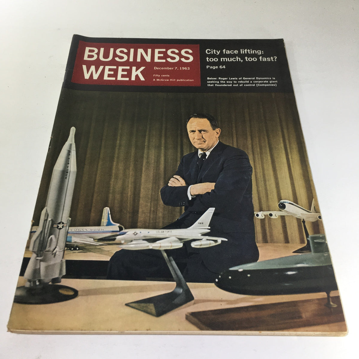 Cover of Business Week Magazine, December 7, 1963, featuring Roger Lewis of General Dynamics with models of aircraft and a missile, showcasing corporate themes of the 1960s.