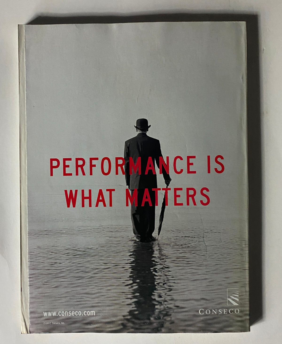 Cover of the February 16, 1998 Fortune Magazine Investor's Guide '98 Special Issue featuring a monochrome image of a man in a suit and hat holding an umbrella, with bold red text stating 'PERFORMANCE IS WHAT MATTERS'.