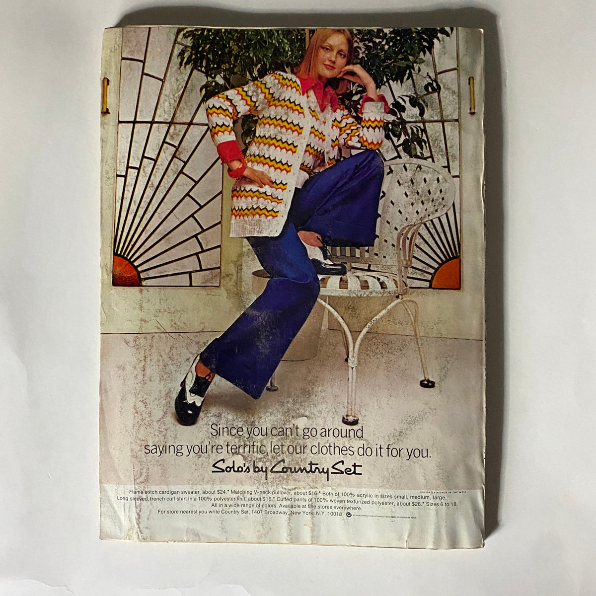 Back cover of Glamour Magazine December 1973 displaying a vintage fashion advertisement for Country Set, illustrating 1970s clothing styles with a model posing in a chic outfit.