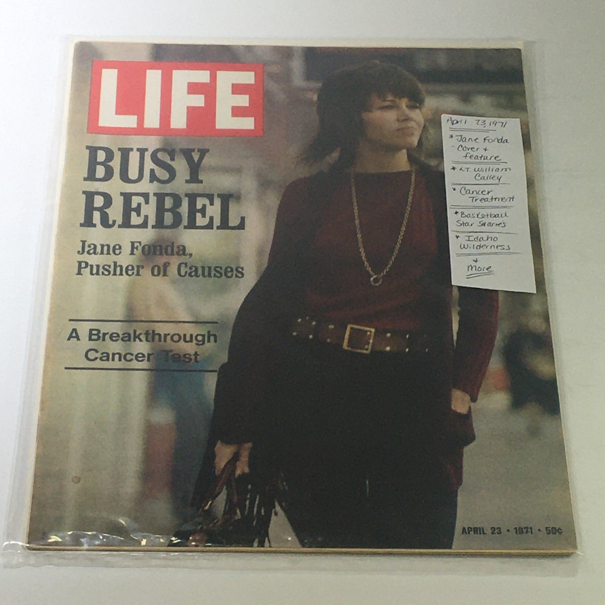 VTG Life Magazine April 23 1971 with Jane Fonda cover, displayed in protective plastic, accompanied by a note outlining key features including Jane Fonda and Lt. William Calley.