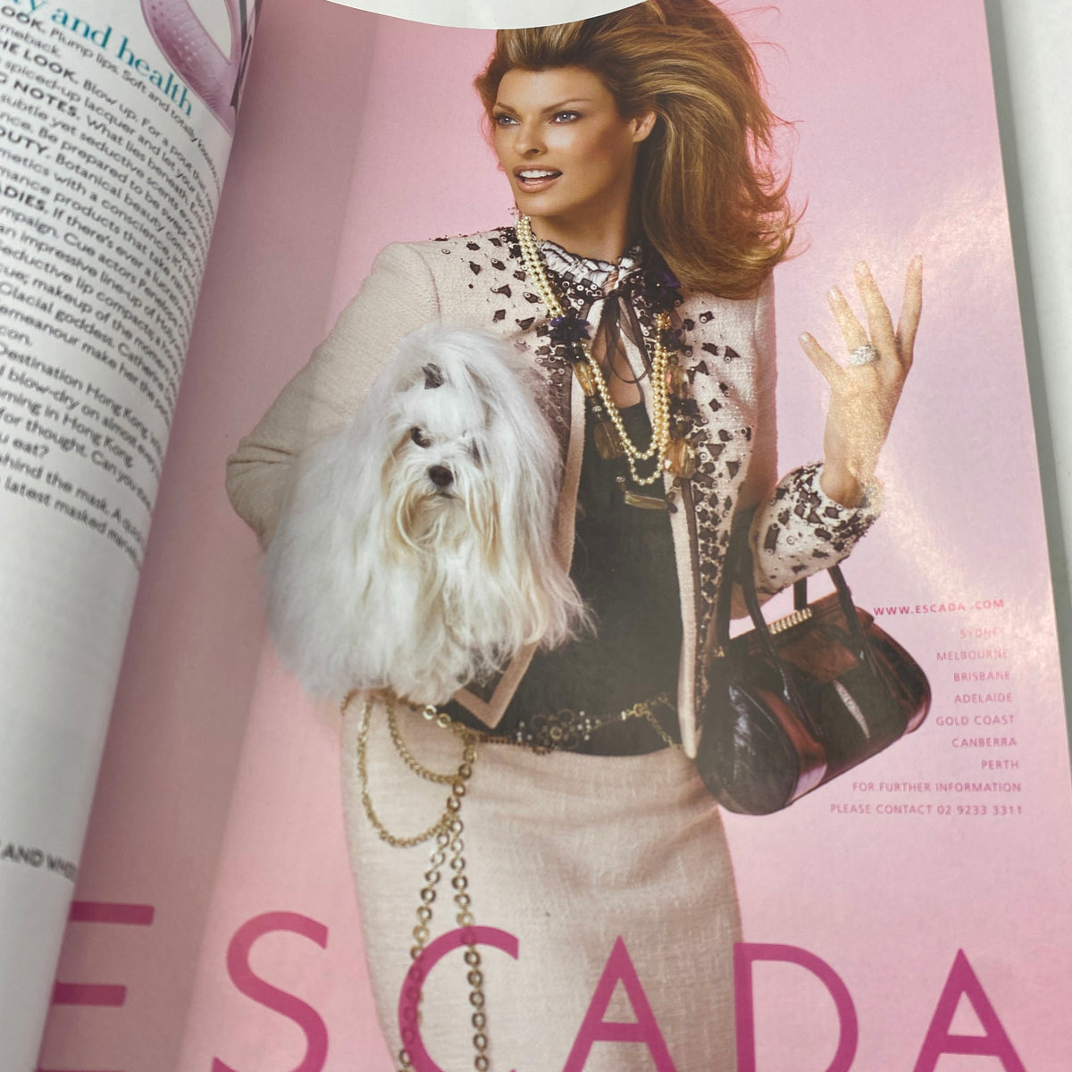 Cover of Harper's Bazaar Australia Magazine March 2006, featuring a model in Escada clothing holding a stylish handbag and a small white dog, representing contemporary fashion of the time.