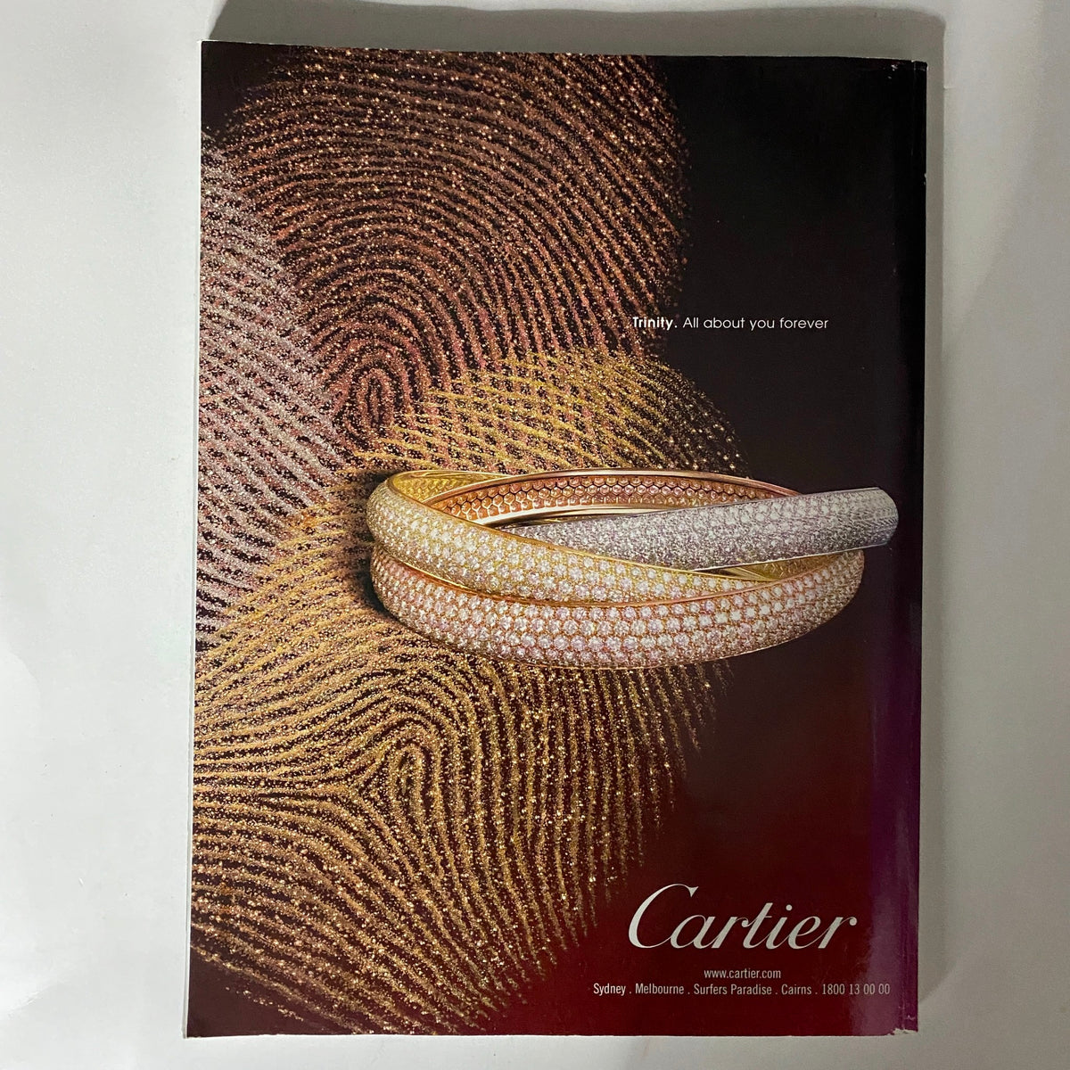 Elegant advertisement for Cartier jewelry from Vogue Australia Magazine October 2009, featuring intricate designs of rings highlighted on a luxurious background.