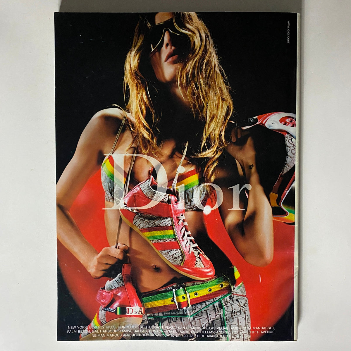 Dior advertisement from Vogue Magazine August 2004, featuring a model in vibrant fashion representing contemporary styles.