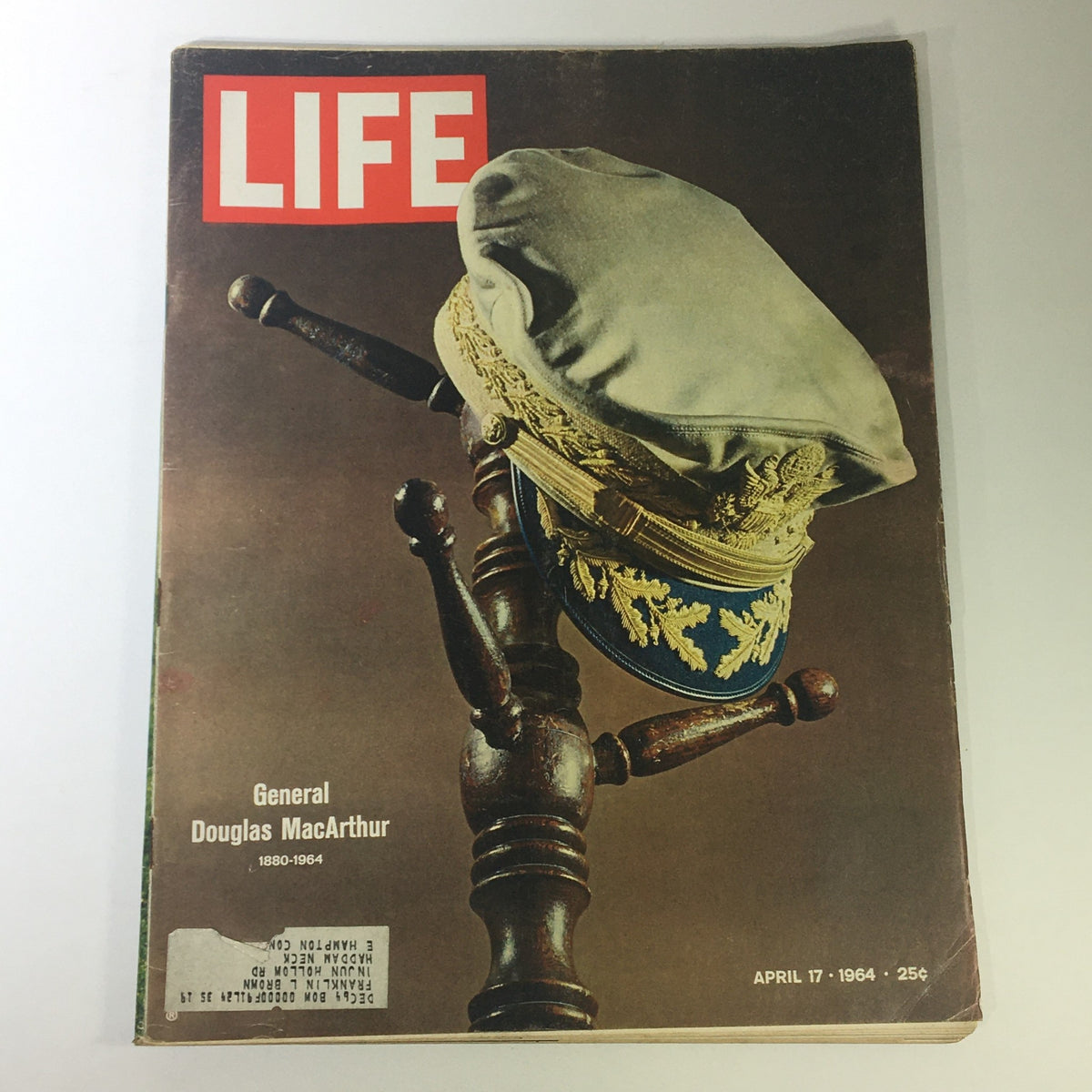 Cover of the VTG Life Magazine from April 17, 1964 featuring General Douglas MacArthur's memoirs, showcasing a military cap resting on a wooden stand with the title 'LIFE' prominently displayed.