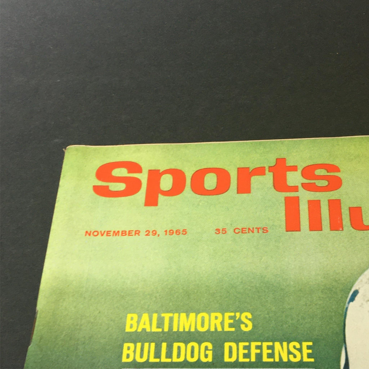 Close-up of the top portion of Sports Illustrated Magazine from November 29, 1965, showcasing the magazine's title and feature on Baltimore's Bulldog Defense.