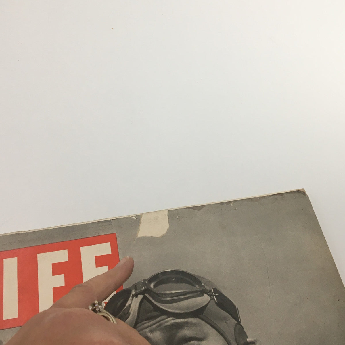 Detail of the VTG Life Magazine May 4 1942 cover, highlighting the top edge with a pointed finger indicating wear, showcasing its vintage character.