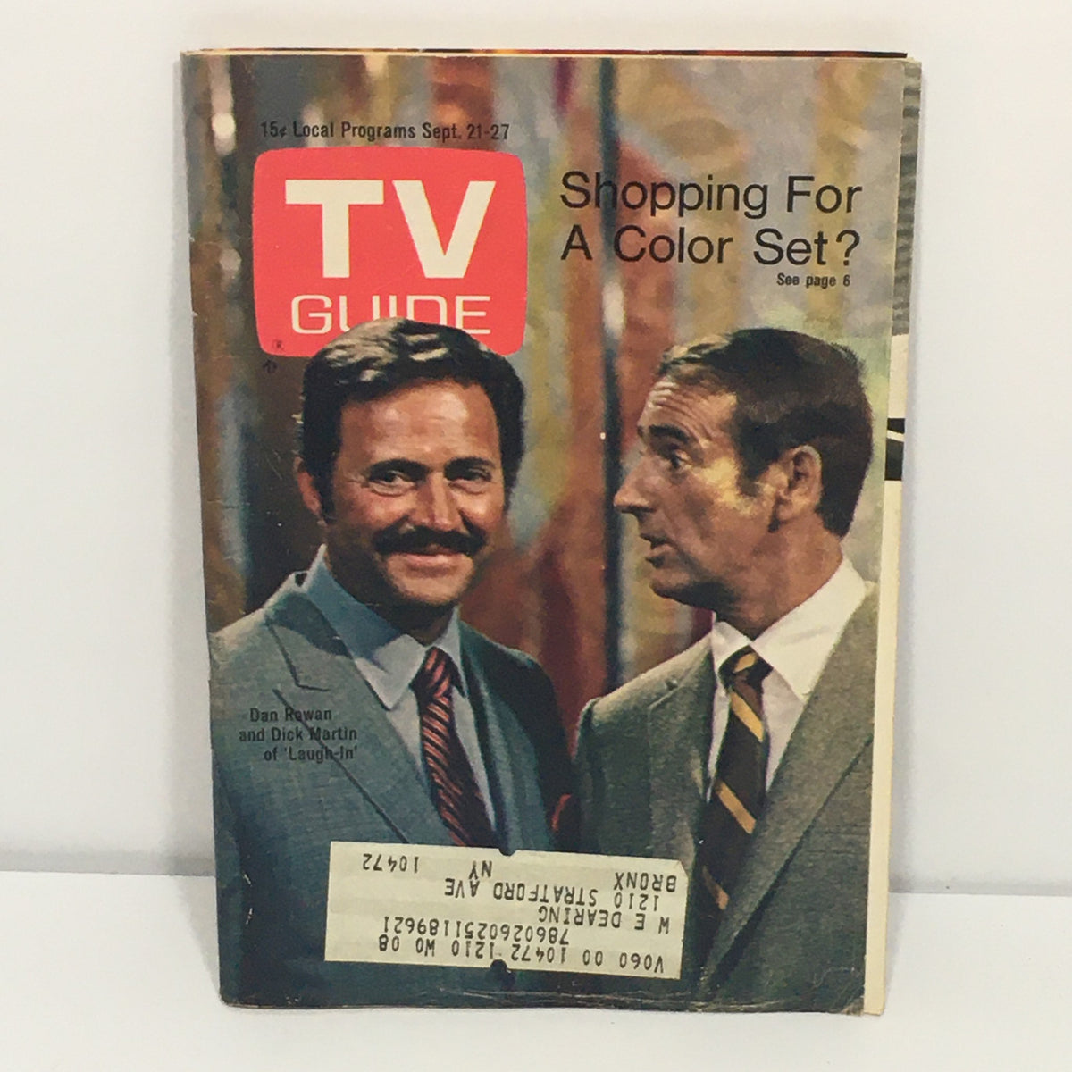 Vintage TV Guide issue from September 21 - 27, 1968 featuring Dan Rowan and Dick Martin from 'Laugh-In'. The magazine cover showcases the iconic duo with a colorful background and promotional text about shopping for a color TV set, perfect for collectors of television history.