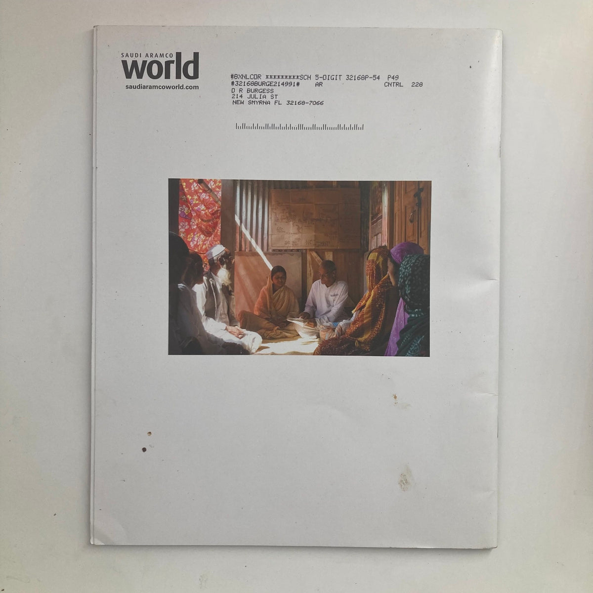 Back cover of Saudi Aramco World Magazine May 2009 displaying an image of a gathering, along with publication details.