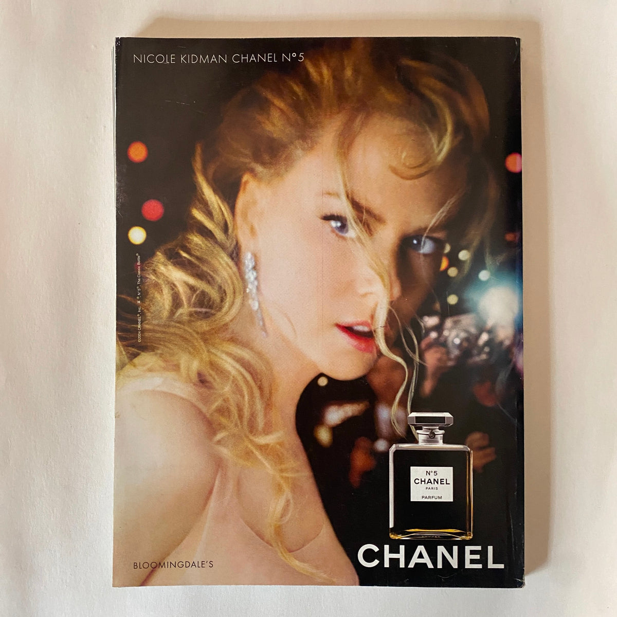 Chanel advertisement featuring Nicole Kidman, showcasing Chanel No. 5 perfume. The image captures Kidman in glamorous lighting, emphasizing luxury and beauty, relevant to fashion enthusiasts.