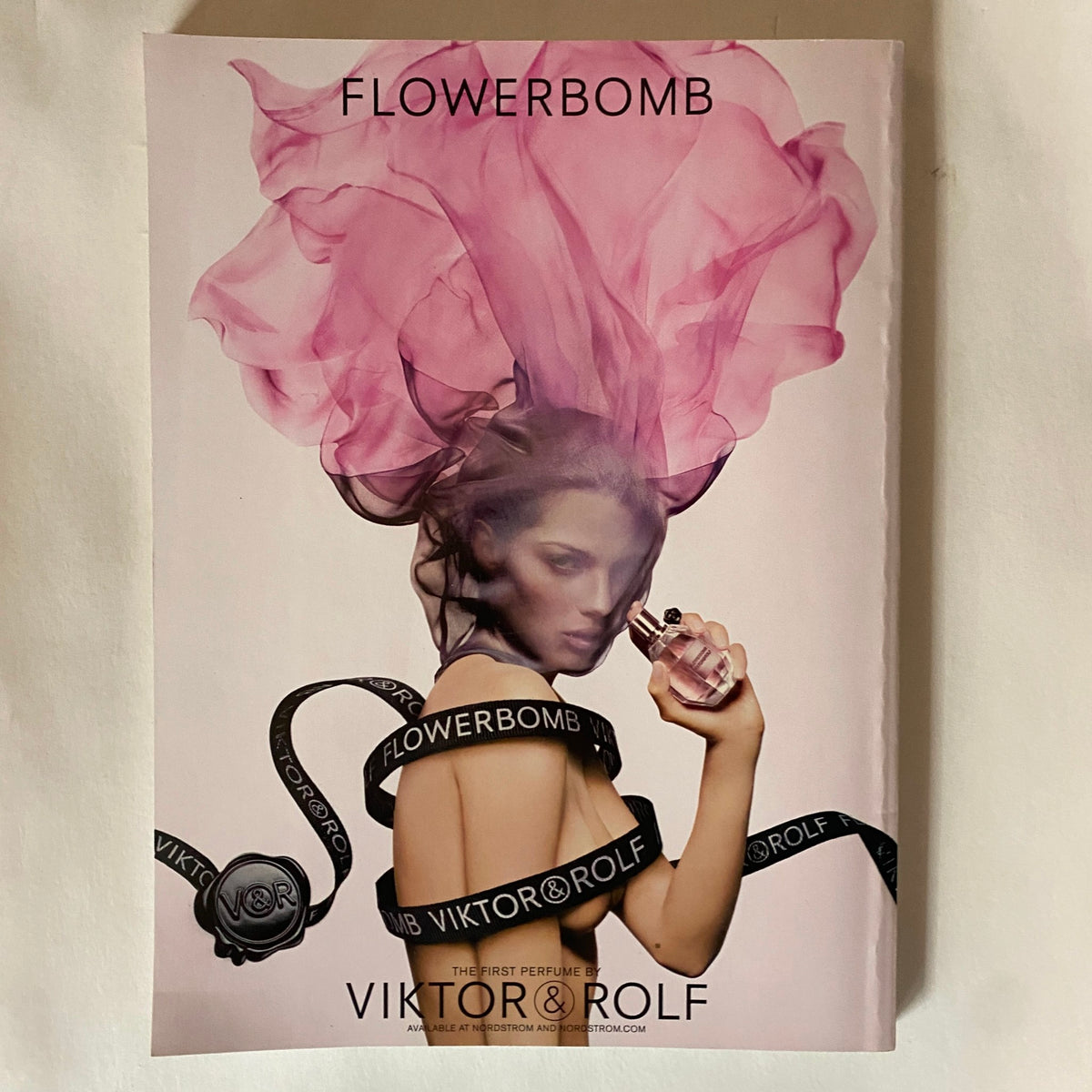 Advertisement for Flowerbomb by Viktor & Rolf in Vanity Fair Magazine May 2008, depicting a model with a floral design theme.