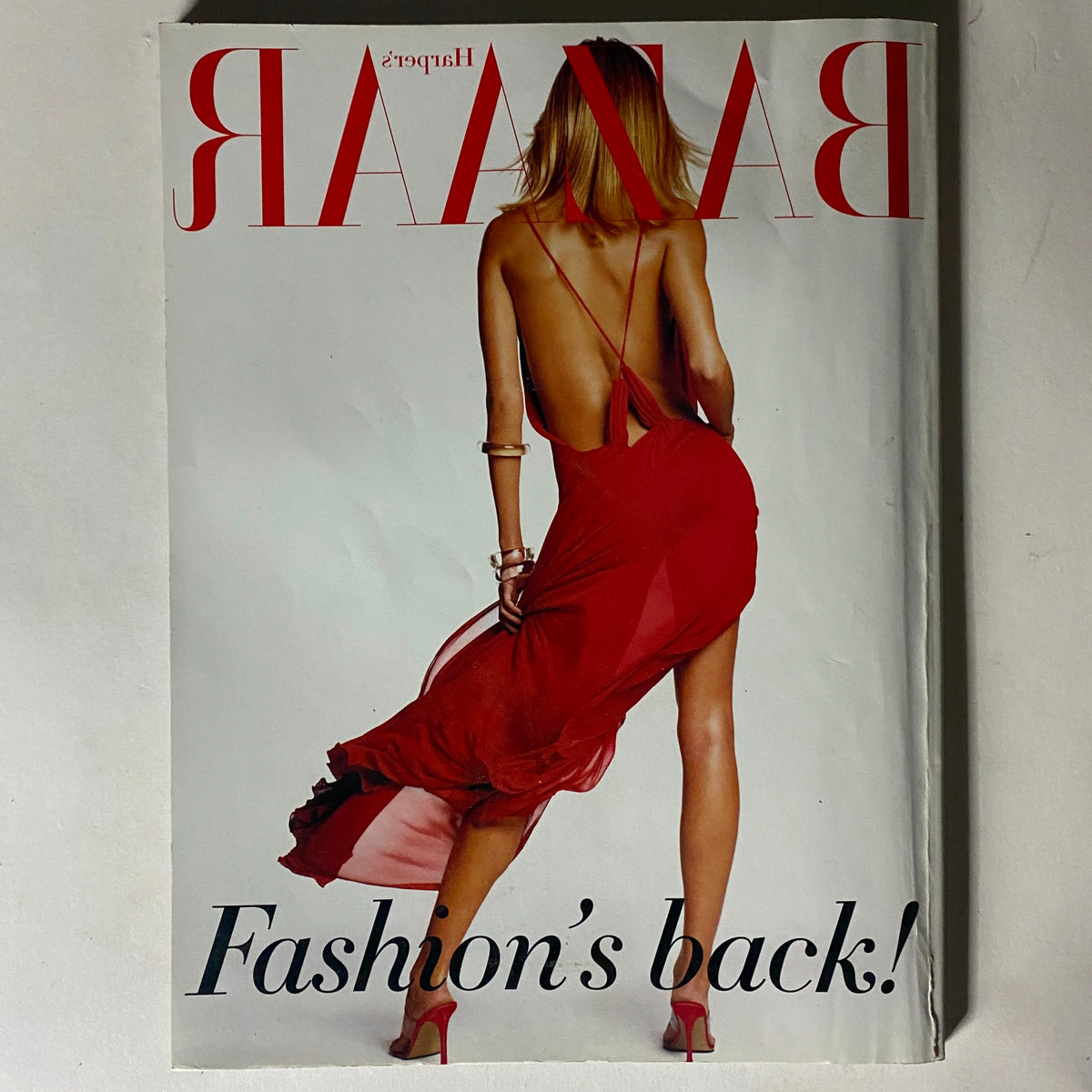 Cover of Harper's Bazaar Magazine February 2002 displaying bold text 'Fashion's Back!' with a model wearing a stunning backless red dress, reflecting vintage fashion trends.