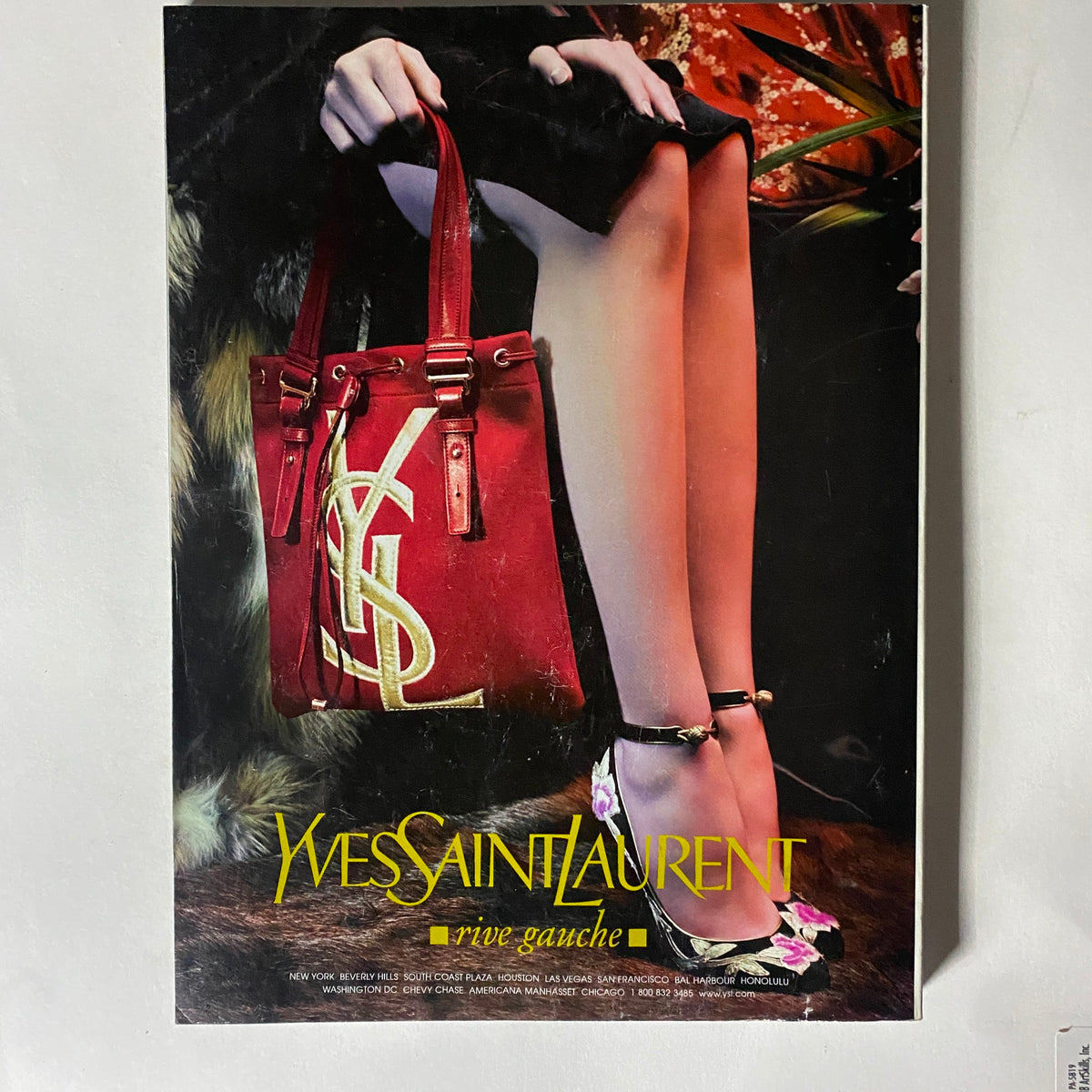 Fashion advertisement for Yves Saint Laurent in the October 2004 Elle Magazine displaying a red handbag and stylish footwear.