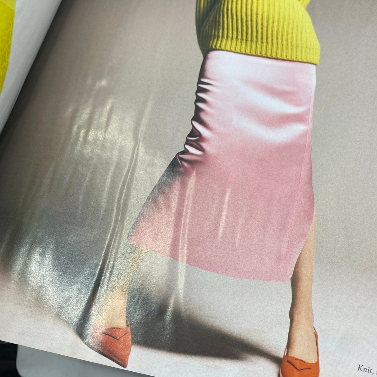 Close-up of a fashion spread from Harper's Bazaar Magazine February 2022, displaying a model in a trendy outfit, highlighting vibrant colors and styles.