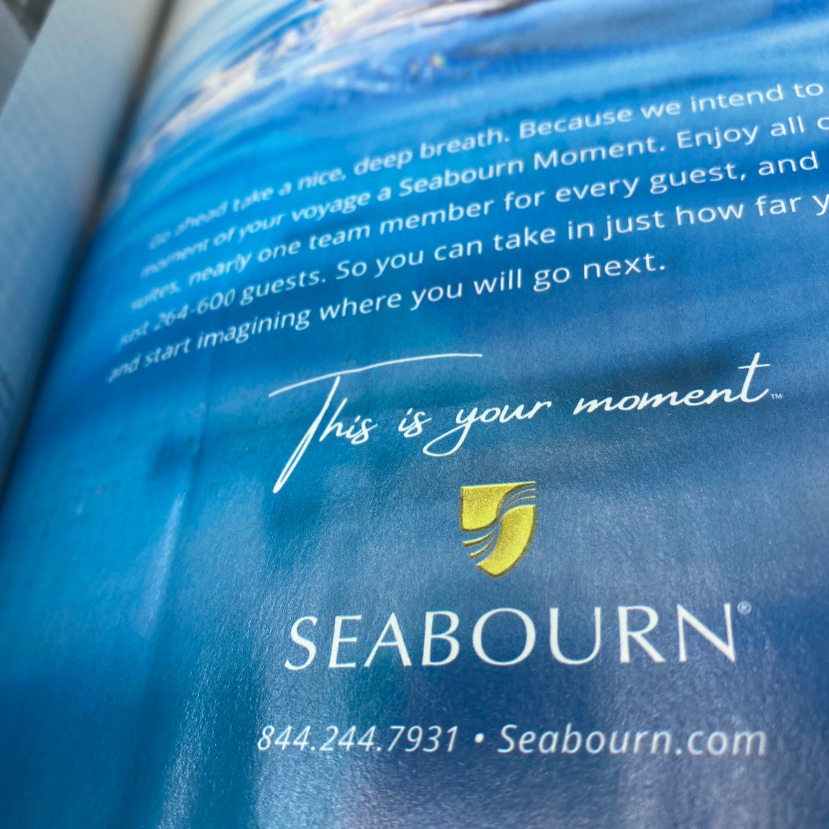 Advertisement page from Harper's Bazaar Magazine February 2022 for Seabourn, promoting luxury travel experiences, featuring an inviting ocean image.