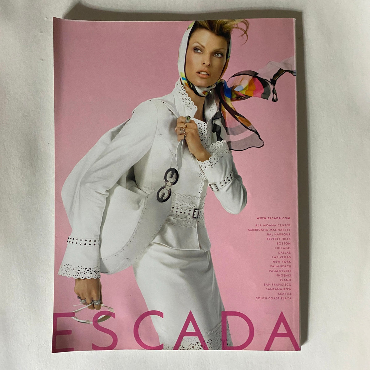 Harper's Bazaar Magazine January 2006 showcases an Escada fashion advertisement featuring a model in a chic white suit, embodying elegance and contemporary style.