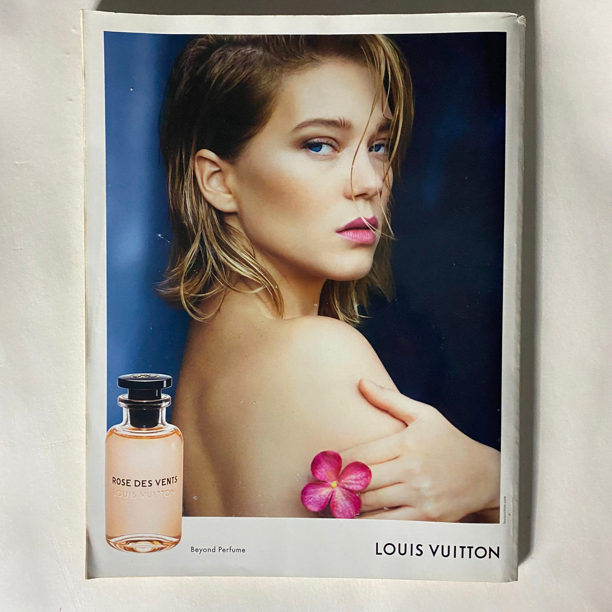 Vogue UK Magazine November 2017 Claire Foy Cover featuring an advertisement for Louis Vuitton's 'Rose des Vents' perfume with a model holding a flower, highlighting beauty and fragrance aesthetics.