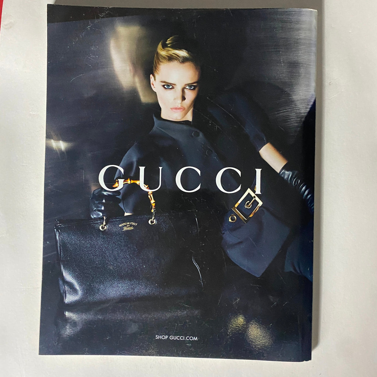 Vogue UK Magazine August 2013 ad featuring a Gucci handbag, emphasizing luxury fashion and accessories.