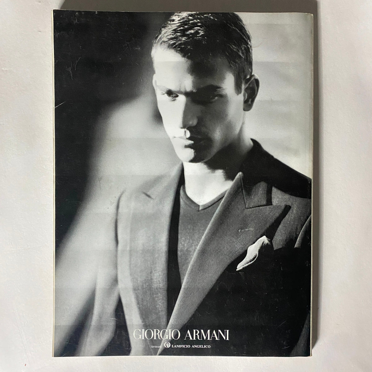 Cover of a Giorgio Armani magazine featuring a model in a dark suit, emphasizing sophisticated men's fashion.