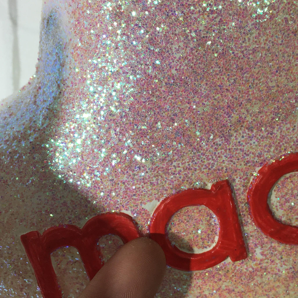 Detailed view of the sparkling star decoration with the 'macy's' logo, showcasing shimmering glitter.