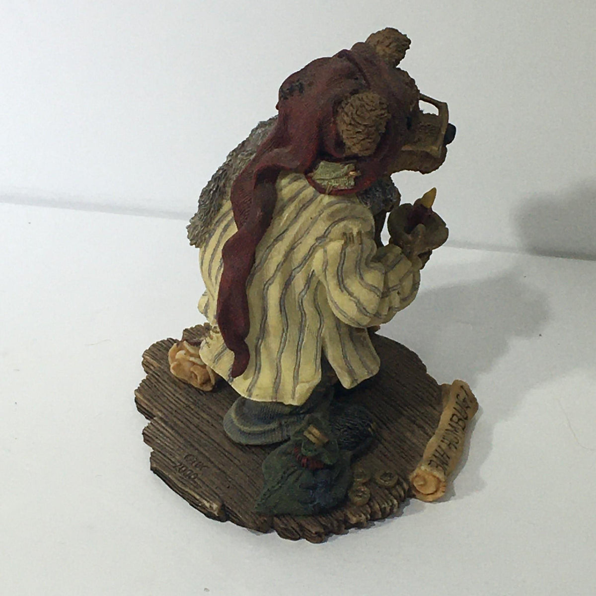 Close-up of the Bearstone Collection style #228333 PAW Scrooge McBear figurine showing detailed craftsmanship, featuring the bear character in a striped outfit, holding a small item, with a festive theme. Bah Humbug!