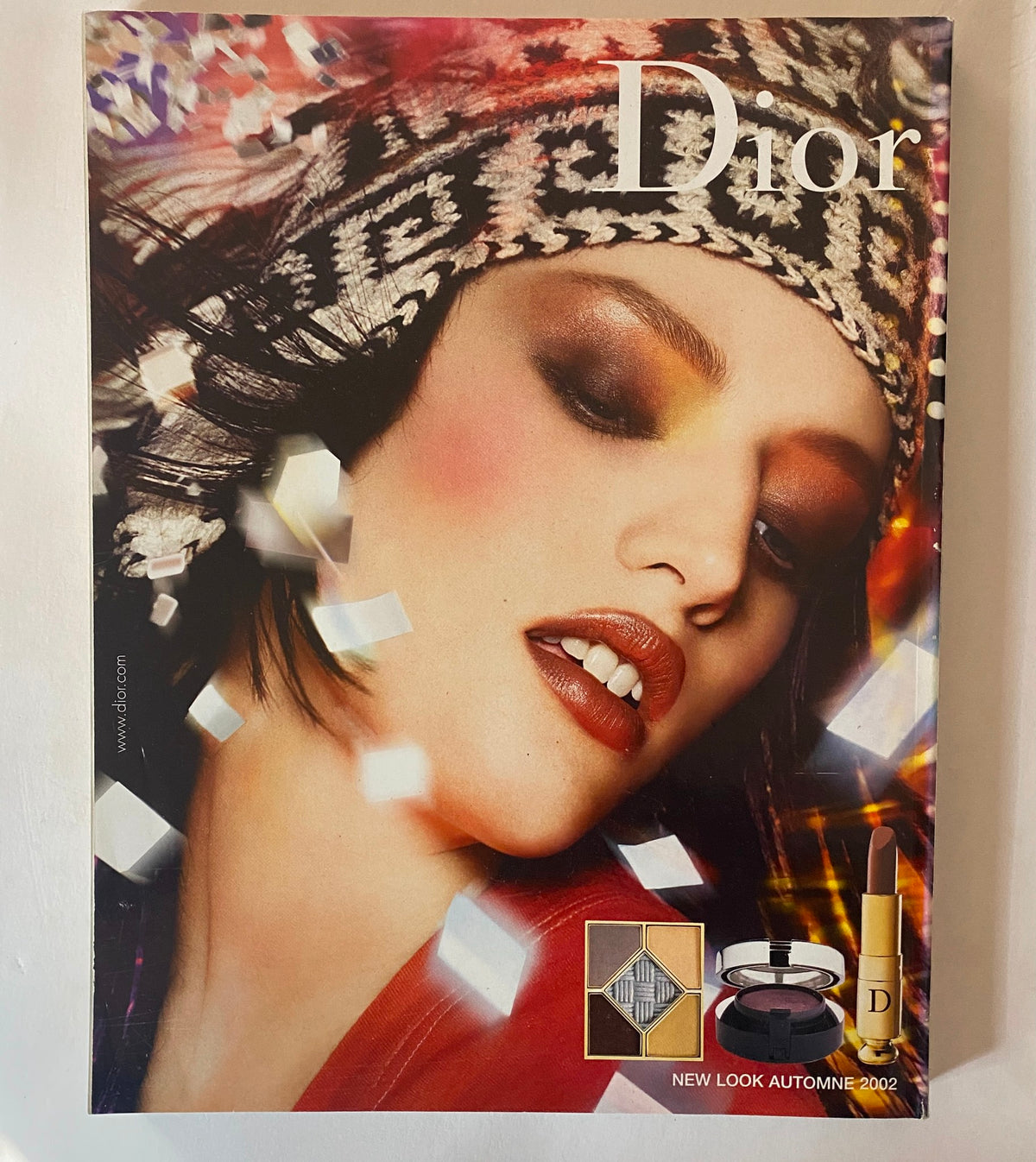 Dior makeup advertisement from Vogue Paris Magazine September 2002, highlighting bold colors and vibrant beauty trends for the fall season.