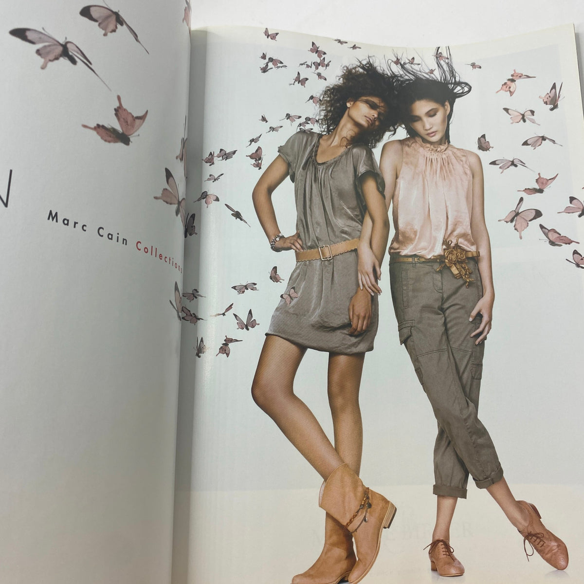 Interior page of Vogue UK Magazine March 2011 displaying a Marc Cain fashion editorial shoot with models in stylish outfits surrounded by butterfly graphics.