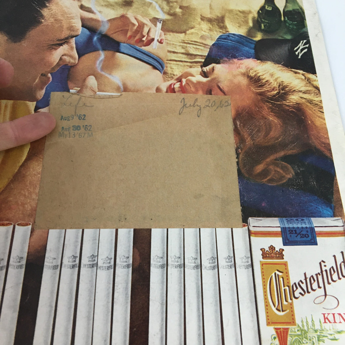 Cover of VTG Life Magazine July 20, 1962 featuring a couple enjoying a moment together, with visible details including a handwritten date and cigarette advertisements showcasing the style of the early 1960s.