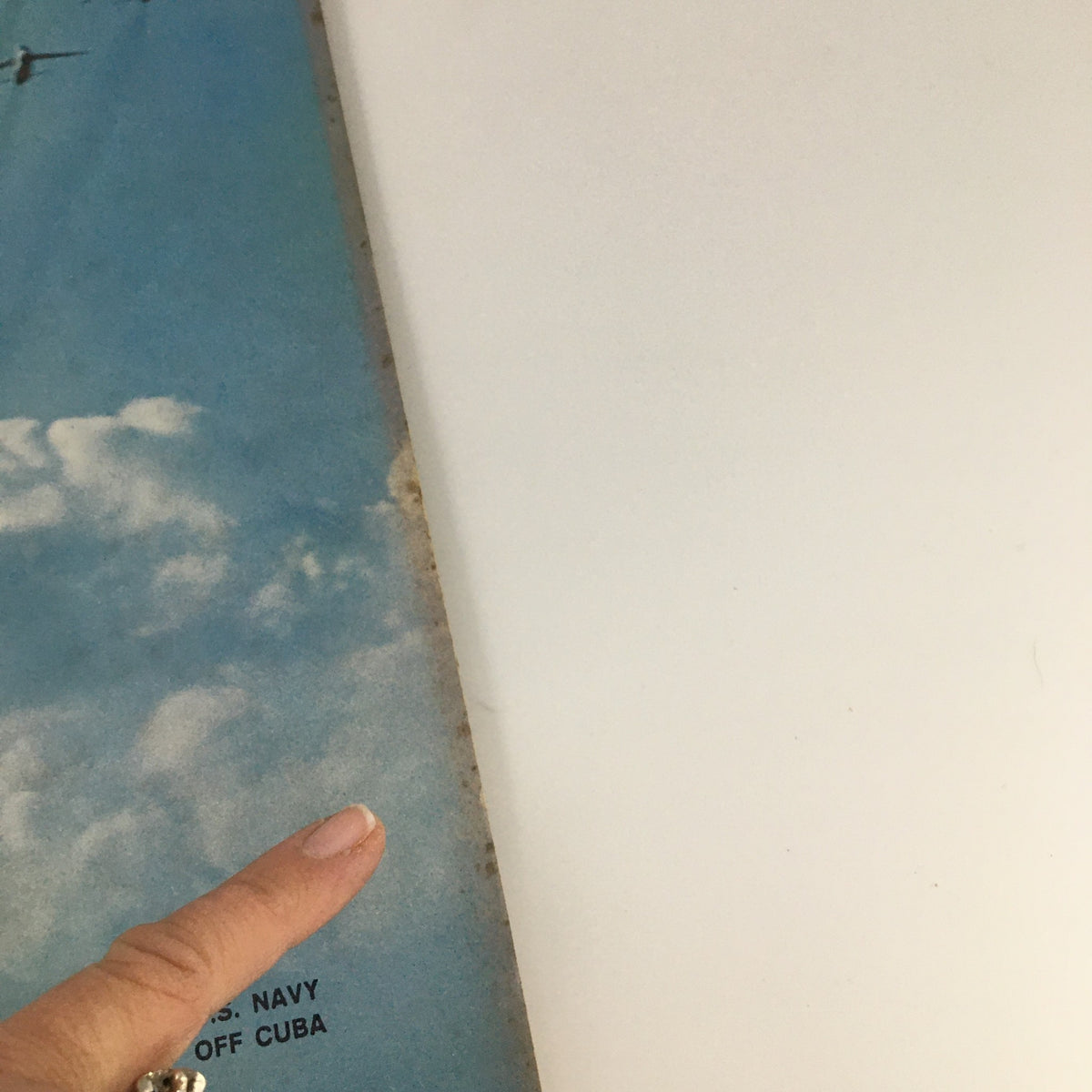 Back cover of VTG Life Magazine November 2, 1962, showing a blue sky and clouds with a finger pointing to text about the U.S. Navy operations off Cuba.
