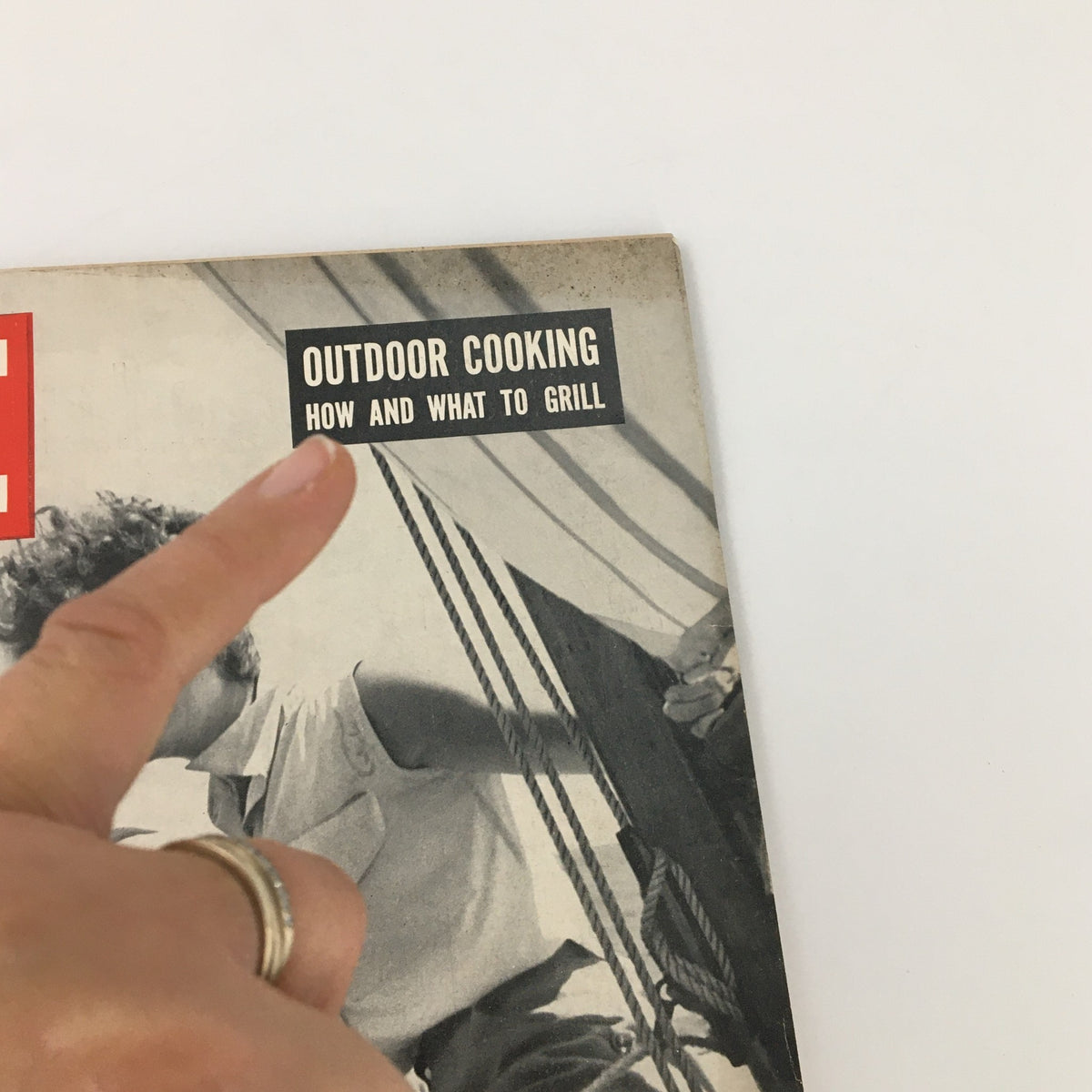 Close-up of the cover of VTG Life Magazine July 20 1953 featuring the title 'Outdoor Cooking: How and What to Grill' with a finger pointing at the title.