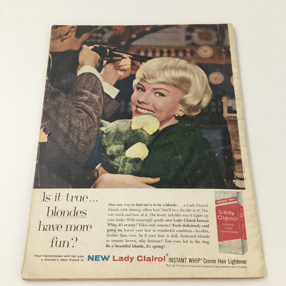 Vintage magazine advertisement featuring a smiling woman with short blonde hair holding a stuffed animal, promoting Lady Clairol hair products, from VTG Motion Picture Magazine April 1959 Dick Clark and Family Cover.