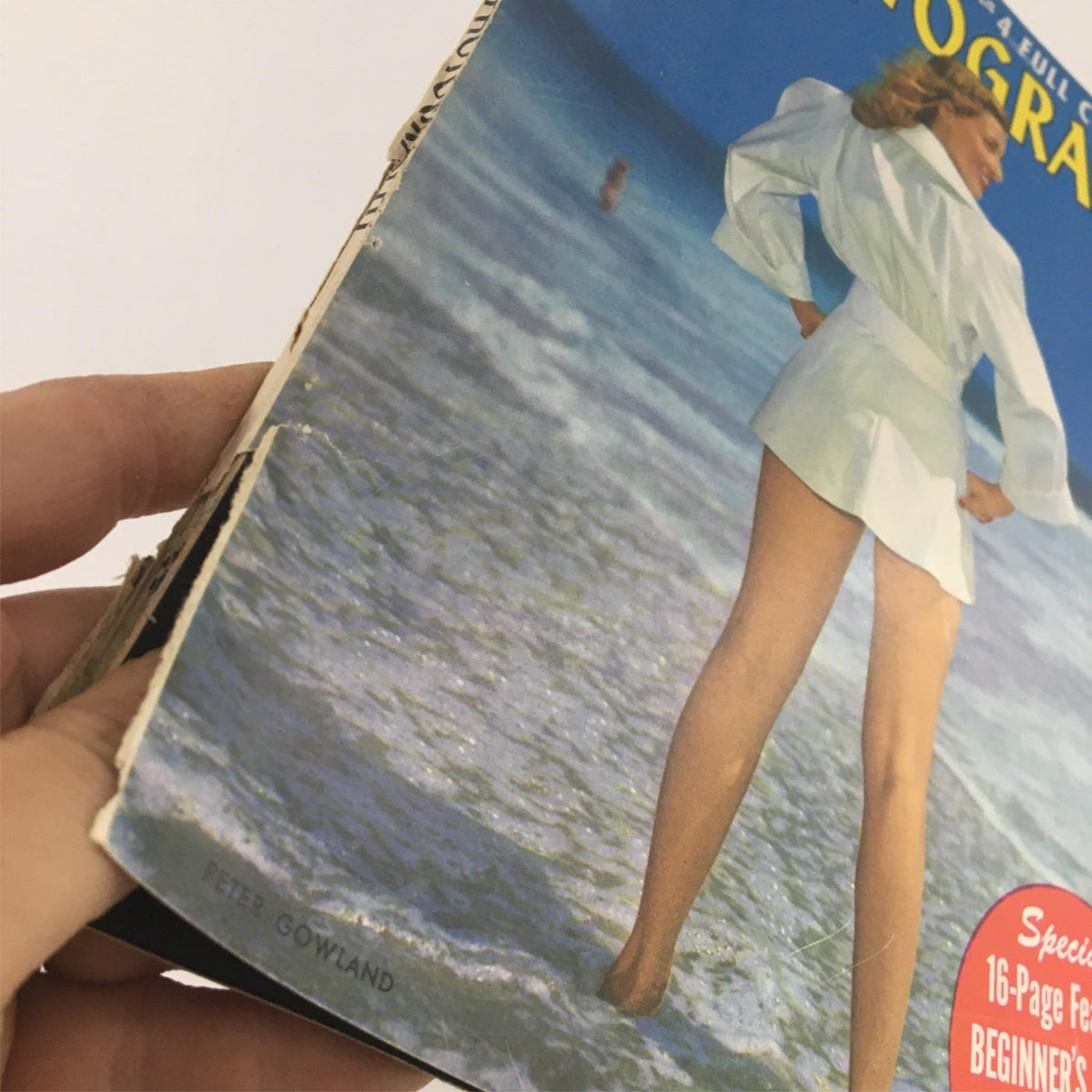 Side view of the Popular Photography Magazine August 1949, illustrating the magazine's edge with a beach image, enhancing its vintage allure.