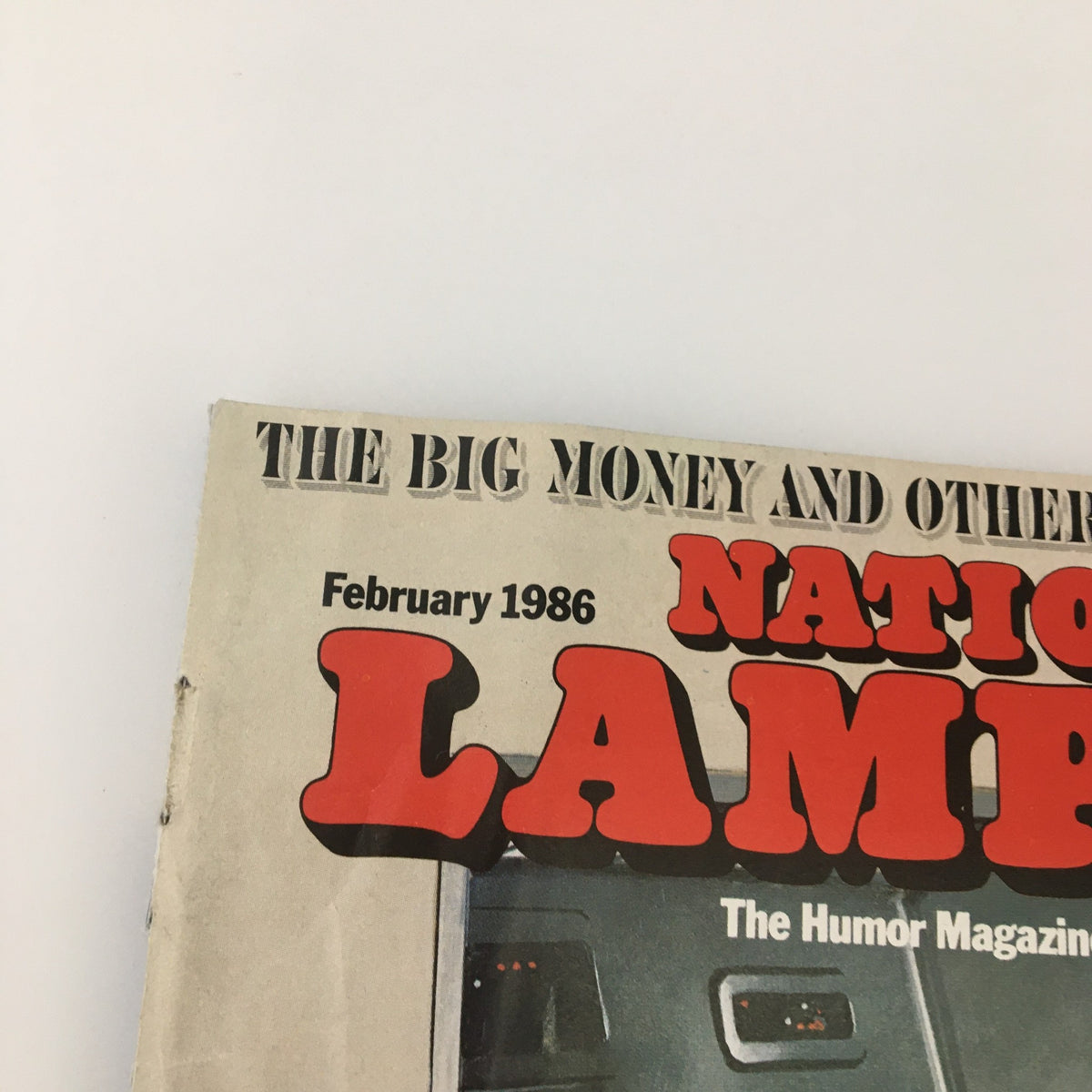 Close-up of the title section of VTG National Lampoon Magazine February 1986, highlighting the magazine's name and the publication date.