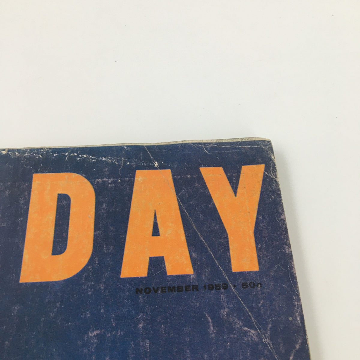 Close-up of the cover of VTG Holiday Magazine November 1959 showing prominent letters and publication date.
