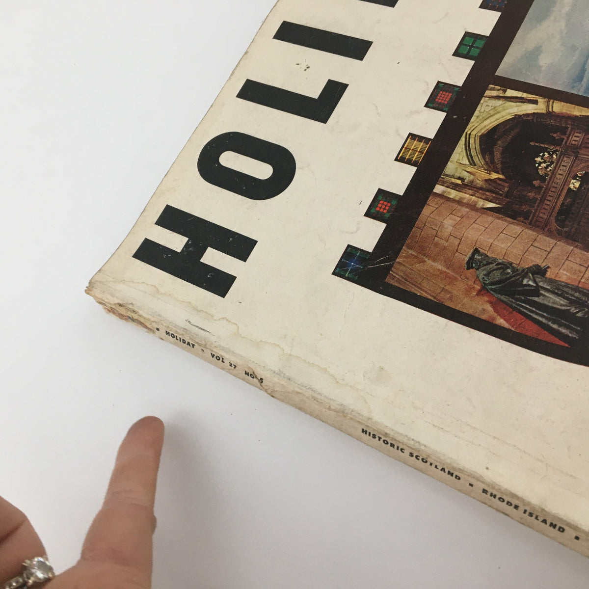 Close-up of the edge of VTG Holiday Magazine May 1960, highlighting the title and wear on the magazine's cover.