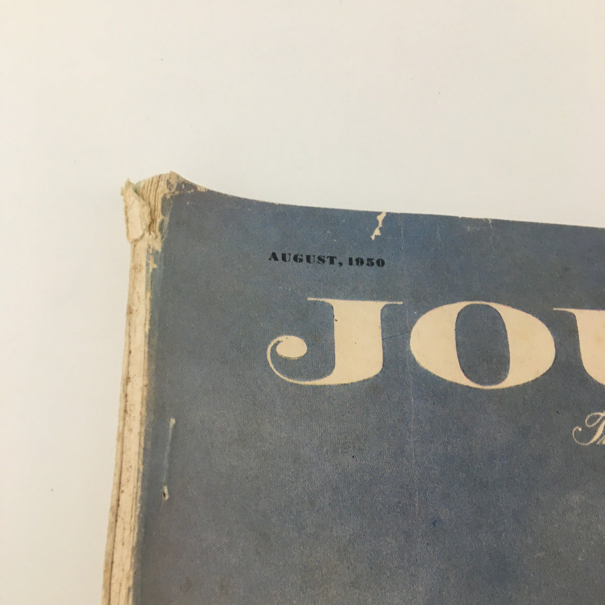 Close-up of the top edge of the VTG Ladies' Home Journal Magazine August 1950, showcasing the magazine title 'JOURNAL' and the issue date.
