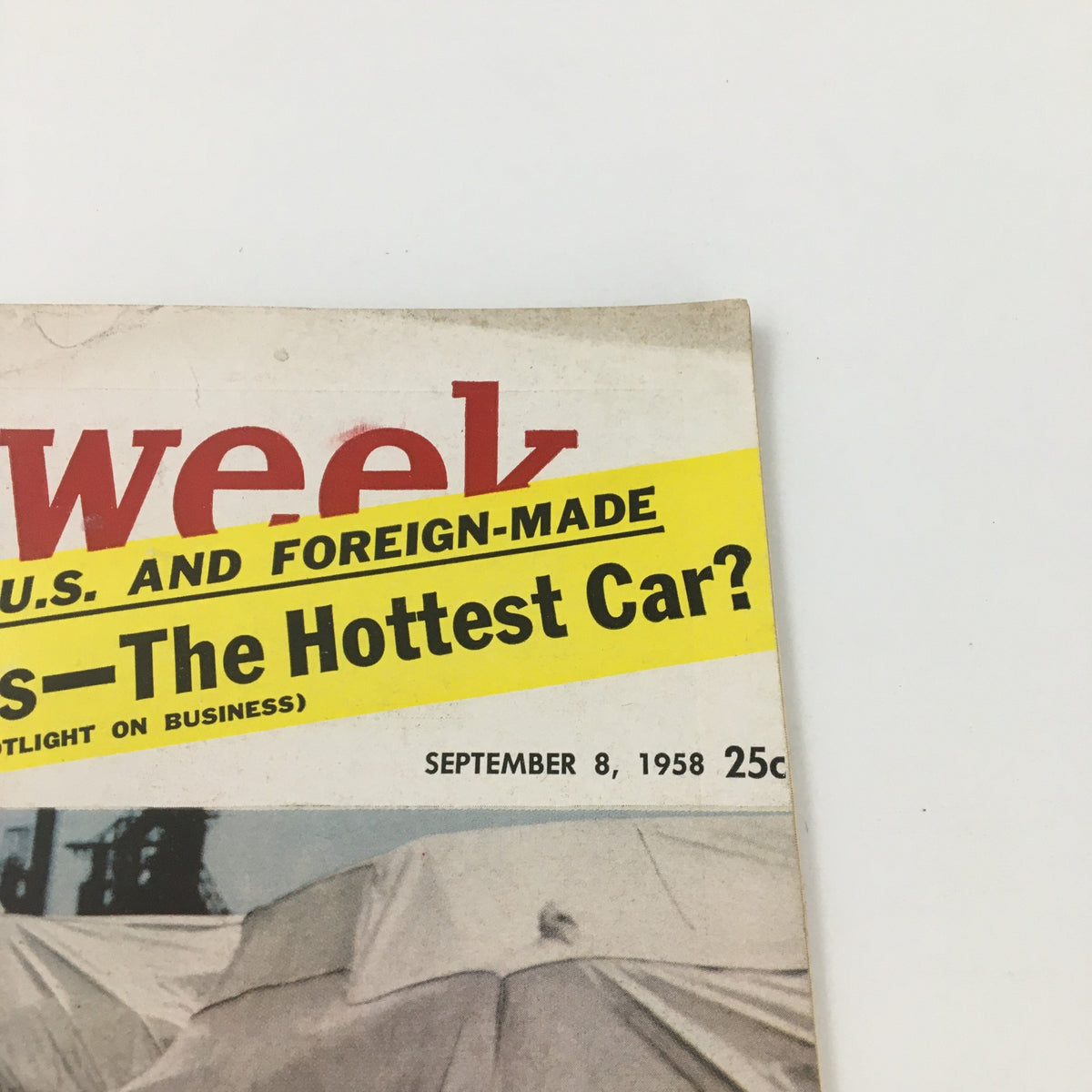 Close-up of Vintage Newsweek Magazine September 8, 1958 showcasing the title 'The Hottest Cars of 1959'. The magazine features an illustrative background with markings typical of vintage publications.