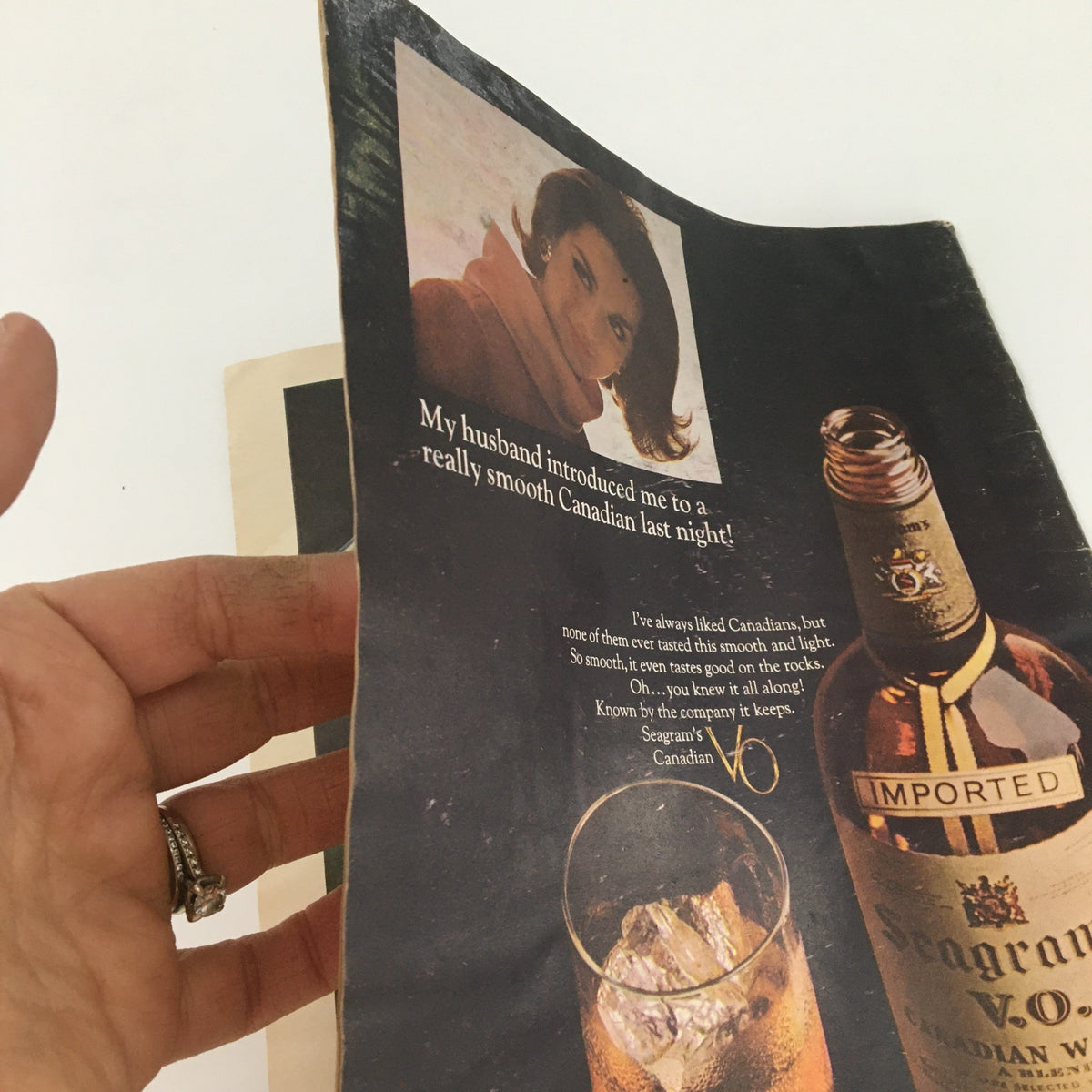 Interior page of the vintage U.S. News & World Report magazine from May 8, 1961, featuring an advertisement with a woman and the text about Canadian whiskey.