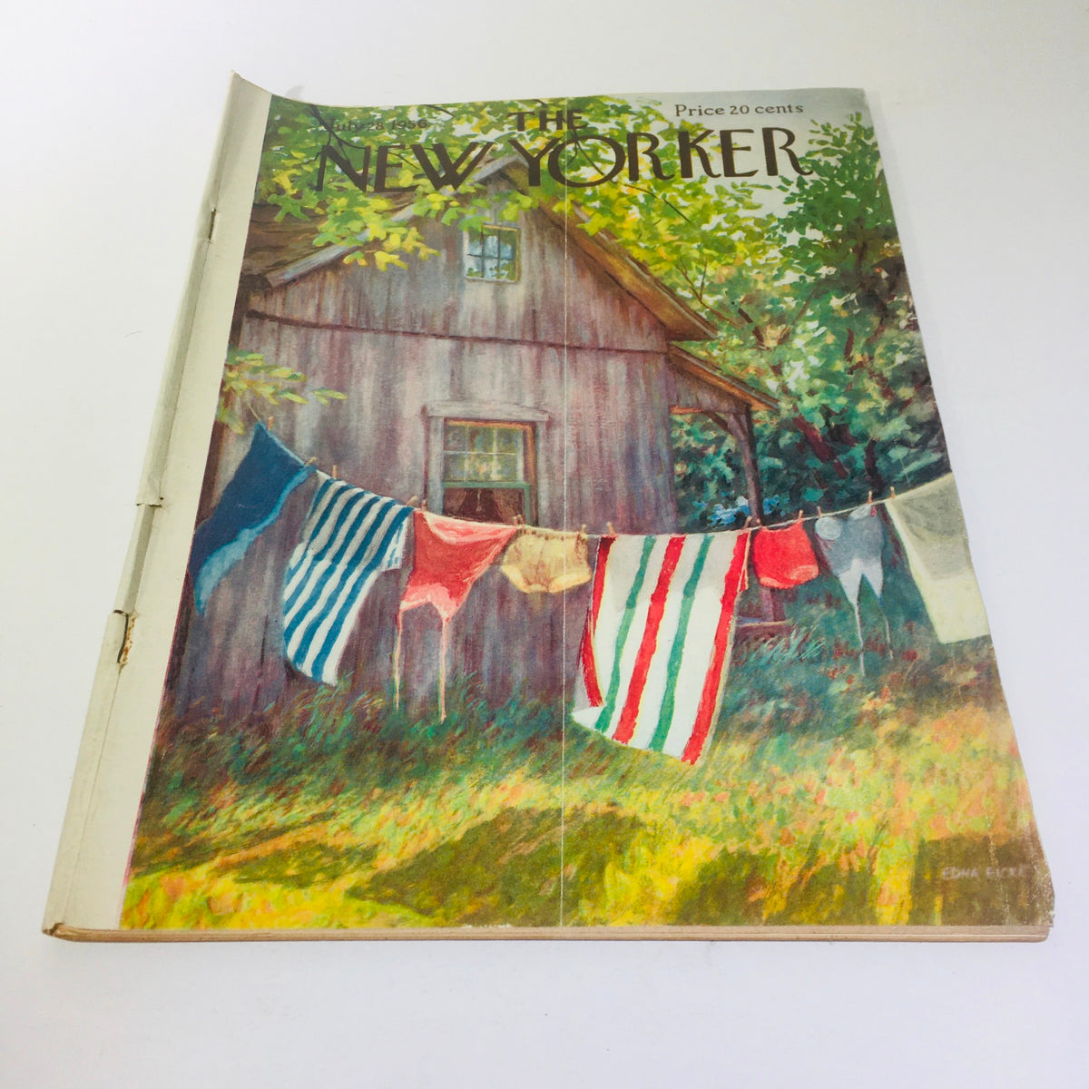 Cover of The New Yorker magazine from July 28, 1956, featuring a vintage illustration by Edna Eicke, depicting colorful laundry hanging on a line in front of a charming wooden cabin surrounded by lush greenery.