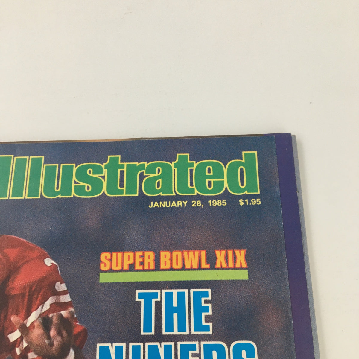 Close-up view of the Sports Illustrated Magazine January 28, 1985 title, featuring the text 'Super Bowl XIX' and 'The Niners Nail 'Em' alongside cover player Roger Craig.
