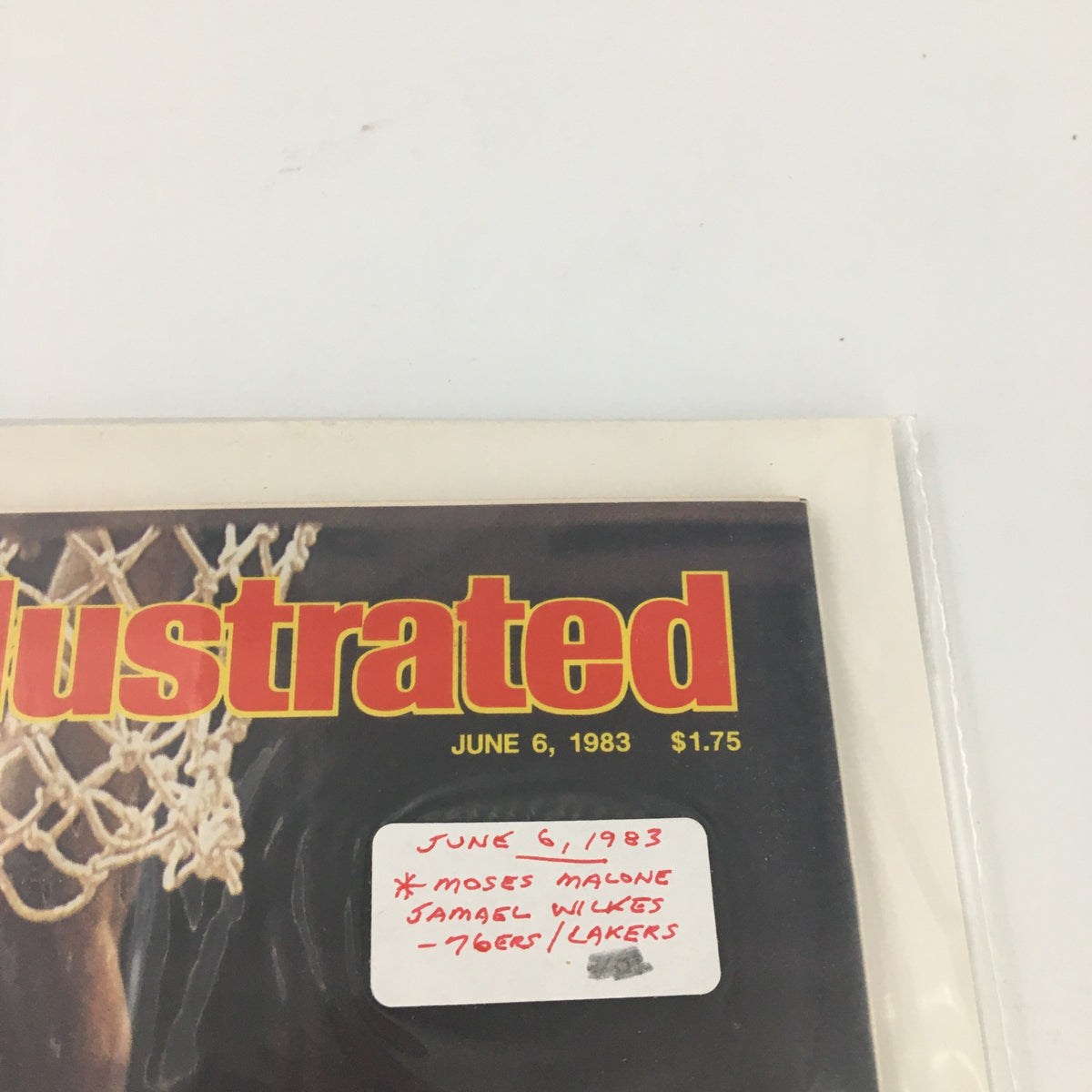 Detail view of the Sports Illustrated magazine cover dated June 6, 1983, highlighting Moses Malone and Jamal Wilkes with notable pricing information, emphasizing its collectible nature.